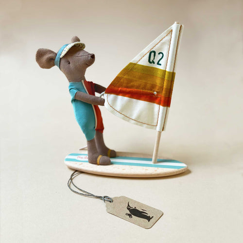 darker-tan-mouse-in-red-and-blue-wetsuit-on-wind-surfin-board-with-white-striped-sail