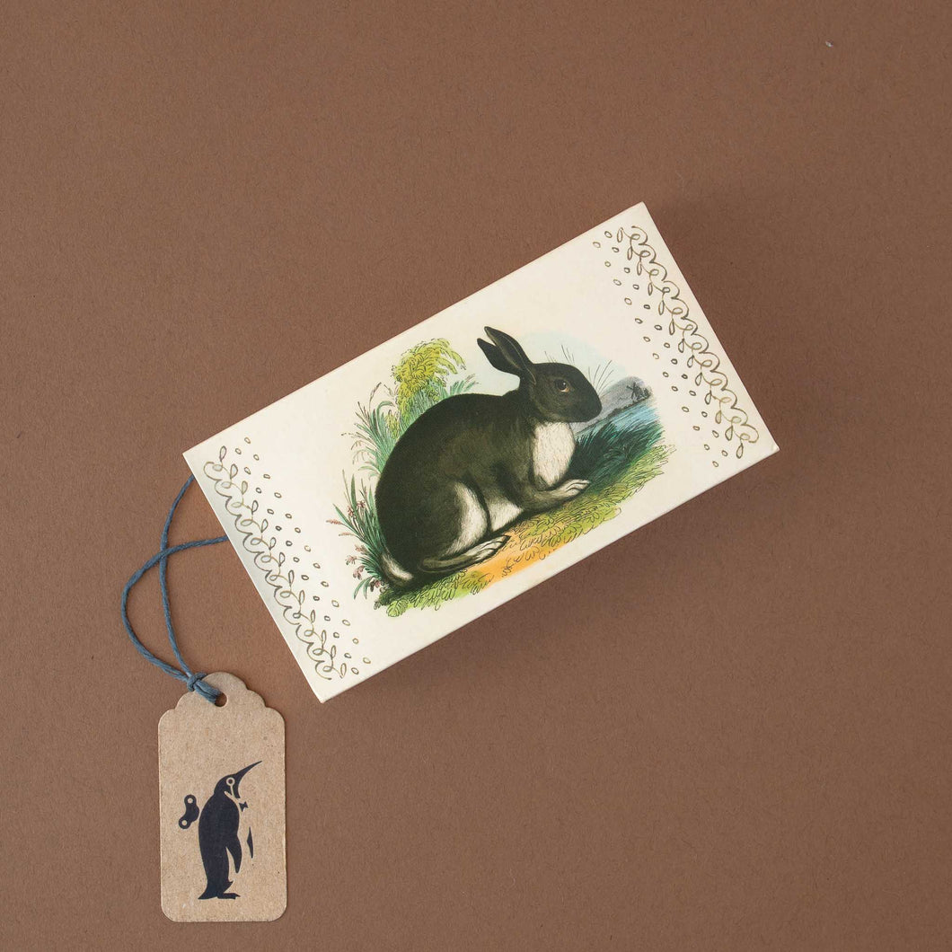 box-of-matches-with-vlack-and-white-rabbit-on-beige-background