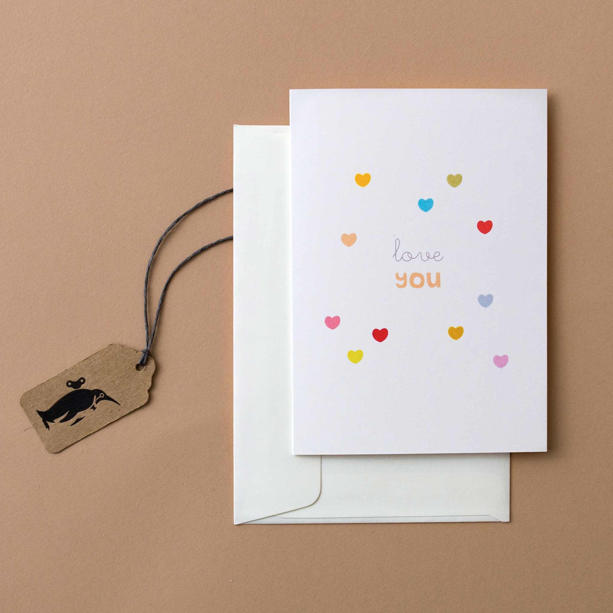 greeting-card-with-the-words-love-you-on-white-background-with-mini-multi-color-hearts