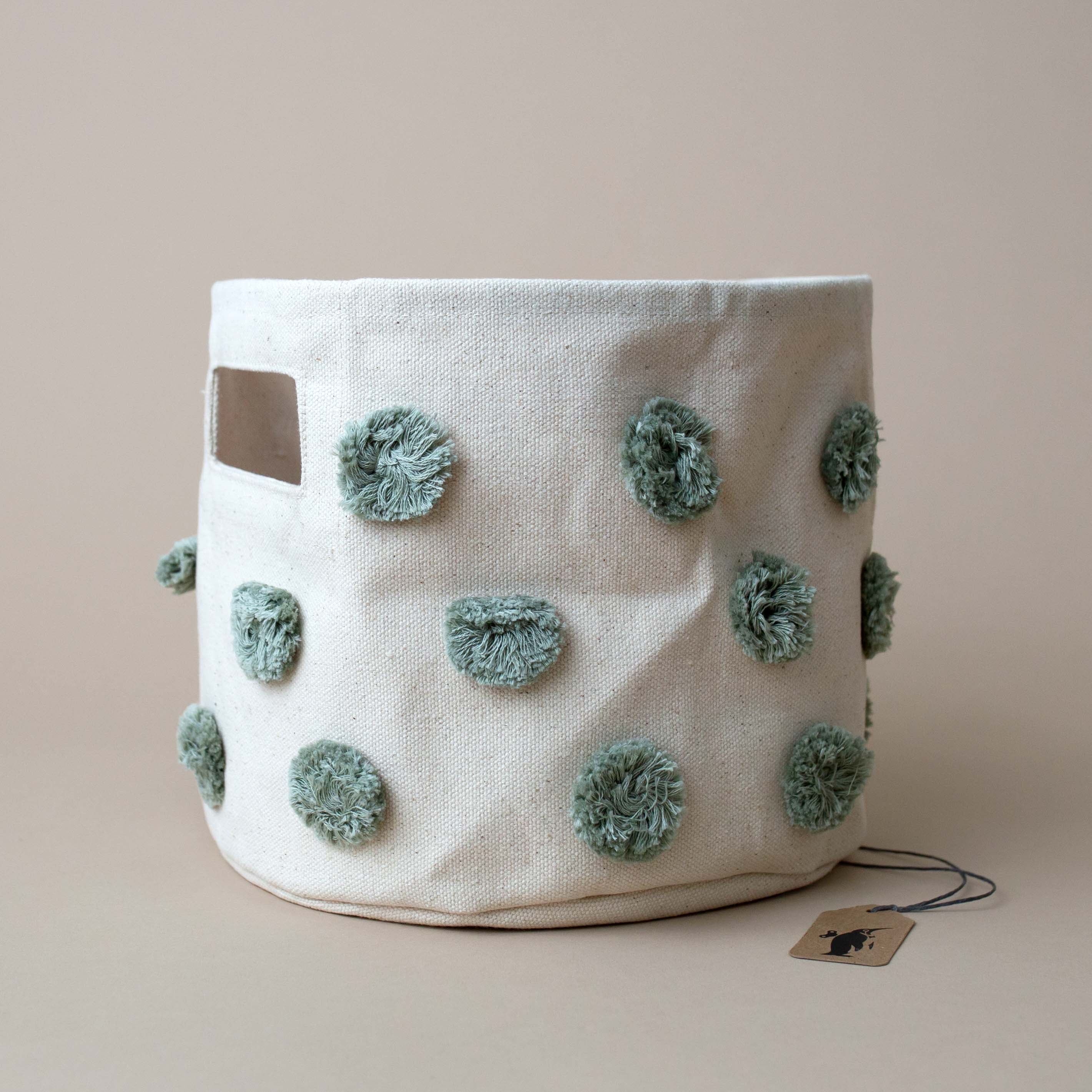 sage-pom-poms-on-natural-canvas-bin