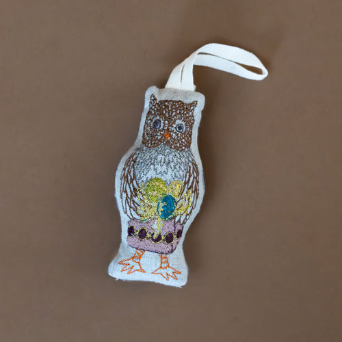 mushroom-owl-embroidered-ornament-carrying-a-gold-laced-present
