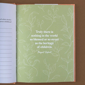 detail-of-green-book-page-with-white-floral-pattern-showing-a-quote