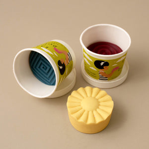dough-containers-laid-around-with-yellow-out-of-container