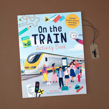 Load image into Gallery viewer, paperback-booklet-in-light-blue-showing-people-waiting-for-a-train