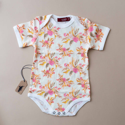 onesie-with-pink-and-orange-vintage-blossoms-on-cream-background