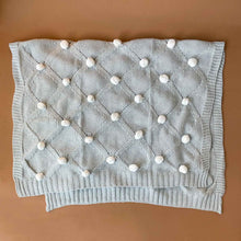 Load image into Gallery viewer, grey-organic-knitted-pom-pom-blanket-with-ivory-poms-unfolded