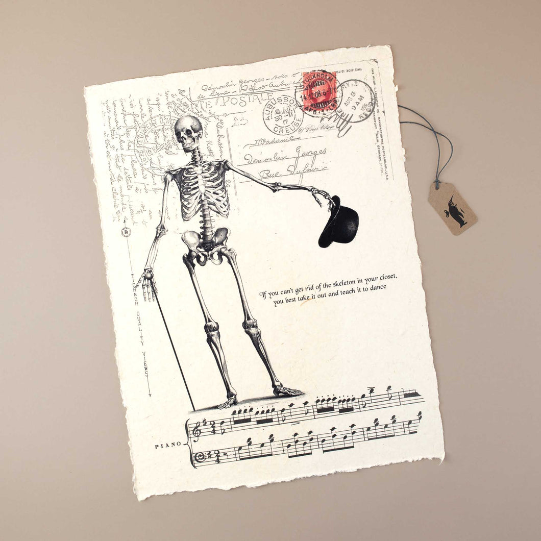 handmade-white-paper-with-skeleton-print-holding-a-stick-and-hat