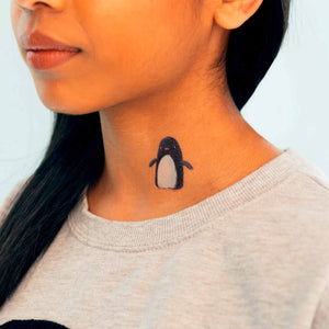 penguin-temporary-tattoo-shown-on-the-neck-of-a-medium-light-skin-model