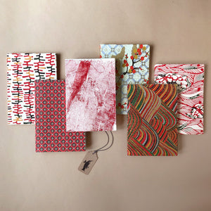 six-petite-hand-bound-notebooks-in-red-tones-ladders-tarlatan-rolling-hills-flower-dot-waves-and-golden-blossoms