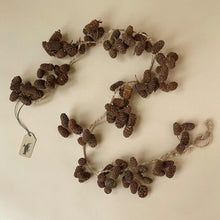 Load image into Gallery viewer, pinecone-garland-curved-into-an-s-shape-with-brown-twine-threaded-through-and-hooked-into-loops-on-either-end