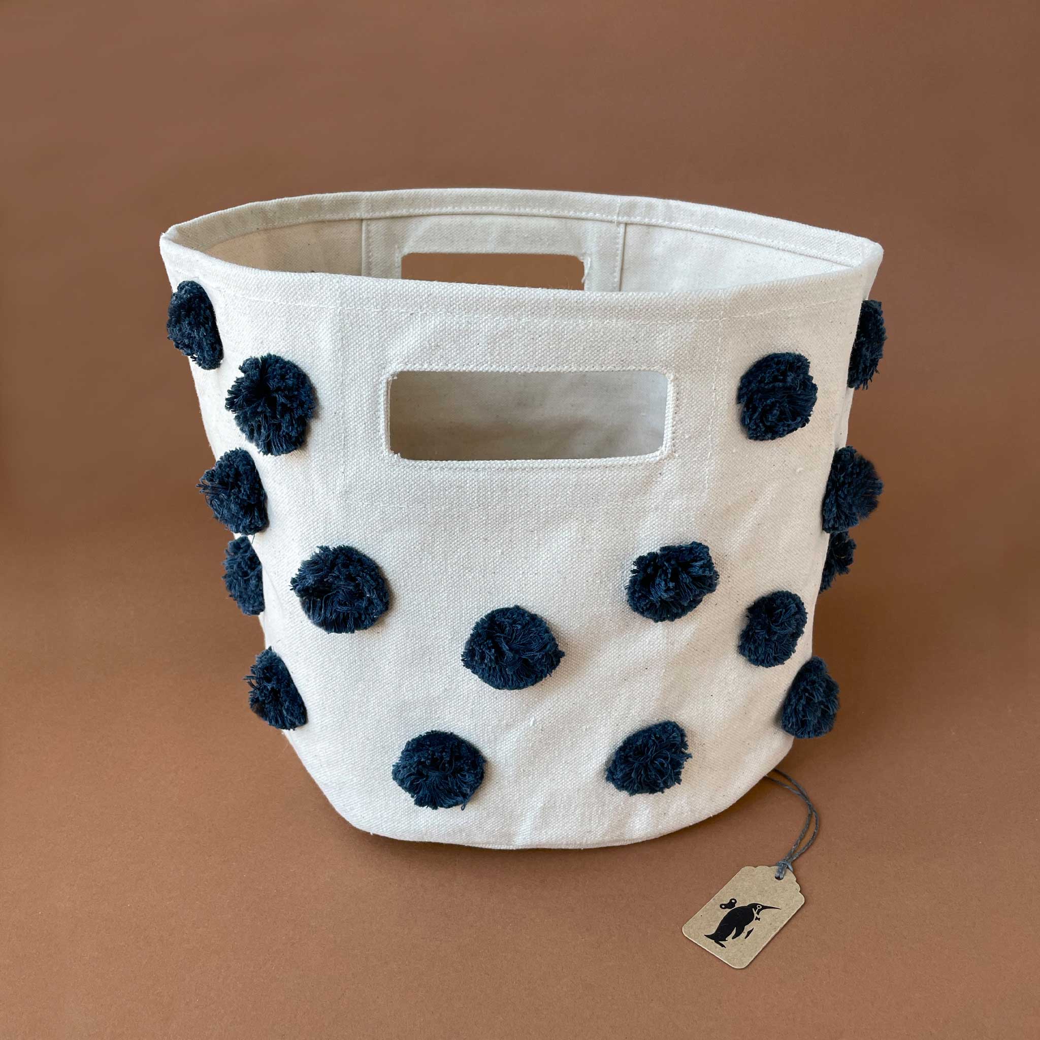 canvas-storage-bin-with-navy-colored-pom-poms