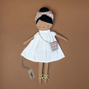 brown-doll-with-black-hair-in-white-dress-with-embroidered-face