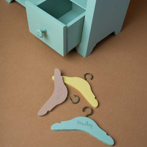 close-up-of-hangers-and-open-drawer