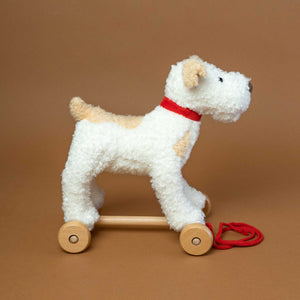 side-view-of-dog-on-wooden-wheels