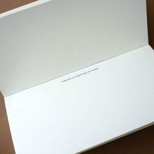 top-view-of-quote-pad-with-forever-is-composed-of-now-in-small-black-text