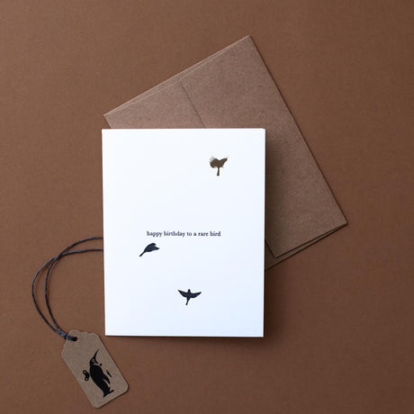 happy-birthday-to-a-rare-bird-in-black-text-with-bird-silohuette-on-white-background-and-craft-paper-envelope