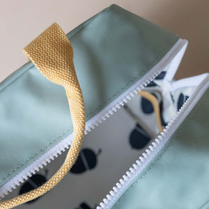 close-up-yellow-handle-white-zip-on-blue-backpack