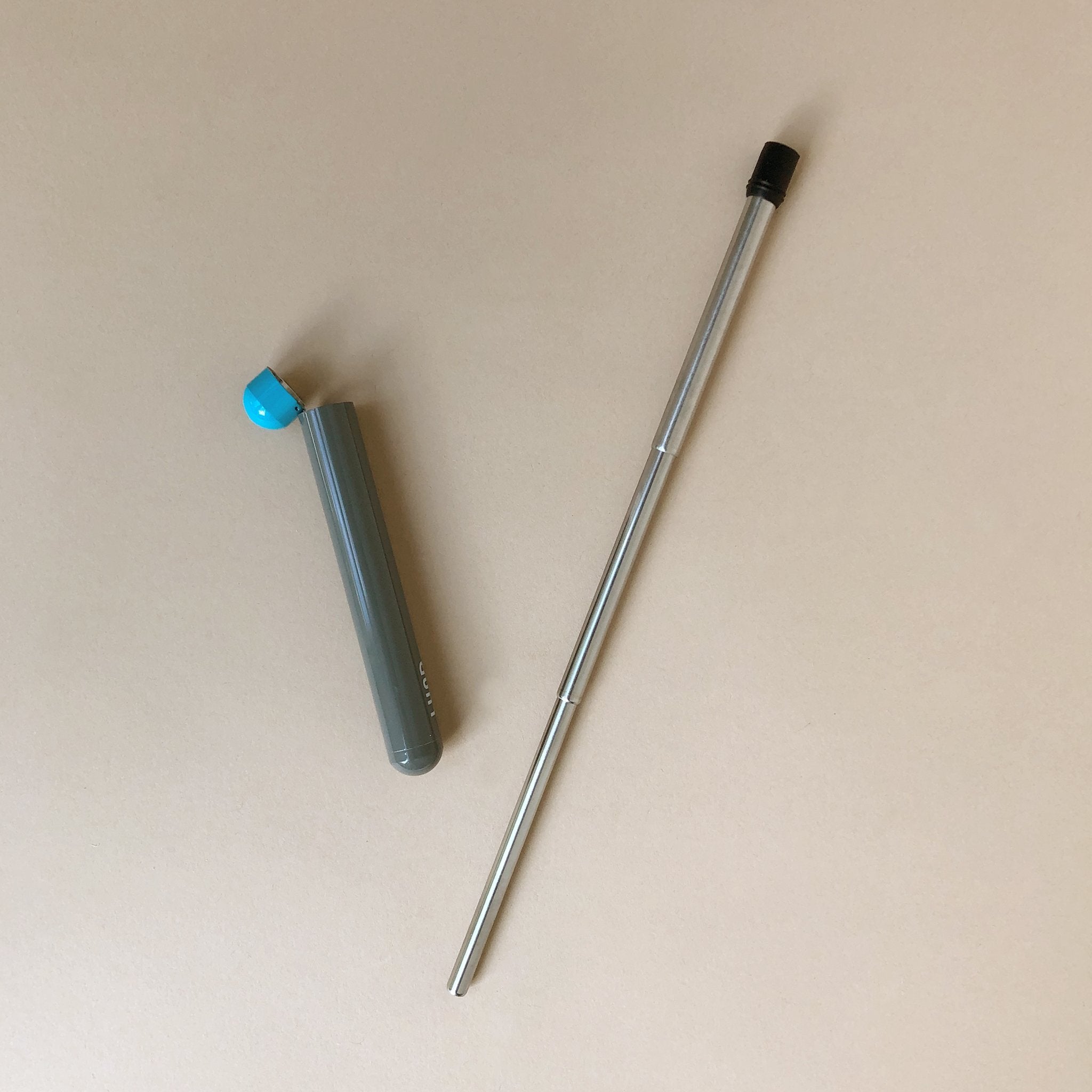 metal-straw-next-to-slate-and-blue-case