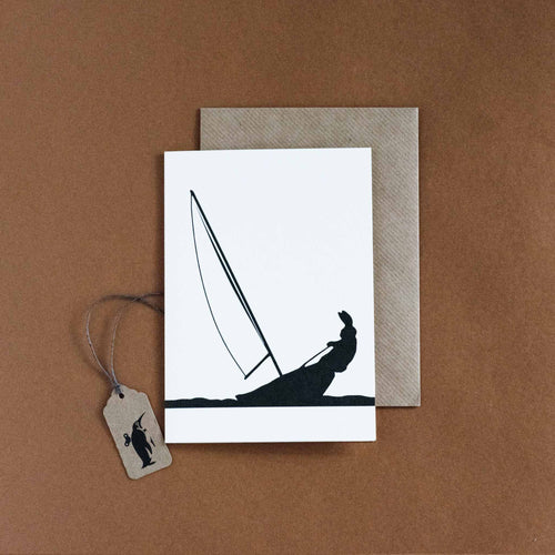 greeting-card-with-black-silohuette-of-rabbit-on-sailing-boat-on-white-background