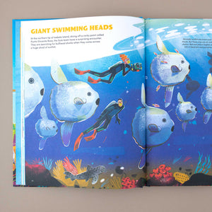 open-book-showing-underwaterworld-with-diver-and-text-about-giant-swimming-heads