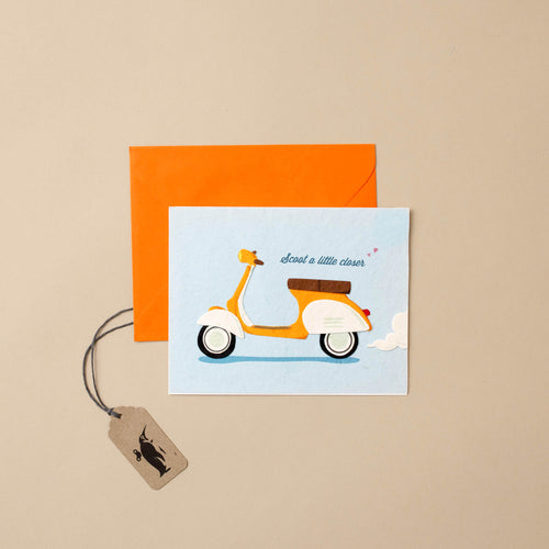 light-blue-card-with-orange-scooter-and-orange-envelope