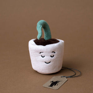 small-beige-plant-pot-with-serene-face-and-single-green-sprout