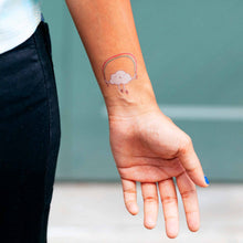 Load image into Gallery viewer, skipping-rainbow-temporary-tattoo-shown-on-inner-wrist-of-light-skin-model