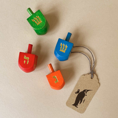 small-dreidel-in-red-green-blue-or-orange-with-gold-hewbrew-letters