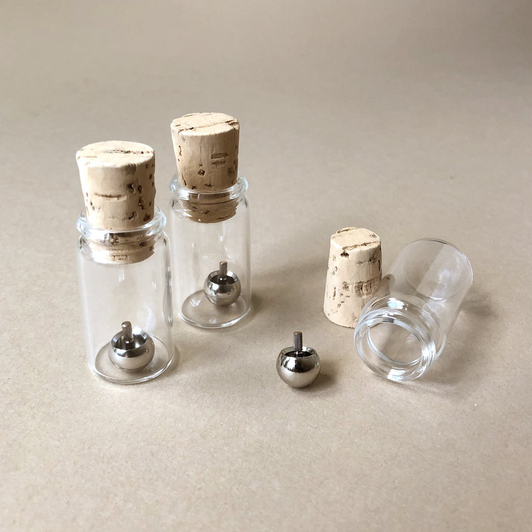 upside-down-metal-tops-in-glass-jars-with-cork-stoppers