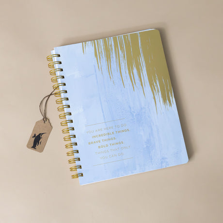  Analyzing image    spiral-notebook-incredible-things-with-soft-blue-cover-and-gold-brush-stroke-and-text