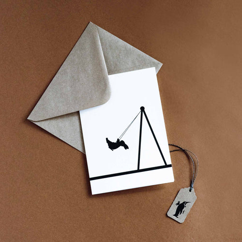 silohuette-of-rabbit-on-park-swing-white-background-and-brown-envelope