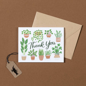 potted-plants-with-thank-you-in-script-on-white-background-and-brown-envelope