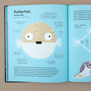 open-book-showing-a-blue-page-and-illustration-of-pufferfish