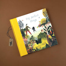 Load image into Gallery viewer, tiny-perfect-things-yellow-spined-book-front-cover-with-parent-holding-child&#39;s-hand-in-beautiful-garden