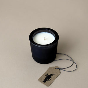 white-candle-in-black-container