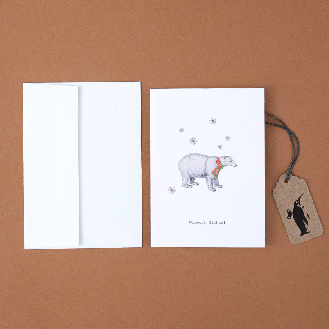 white-greeting-card-illustrated-polar-bear-in-scarf-and-black-text-reading-warmest-wishes