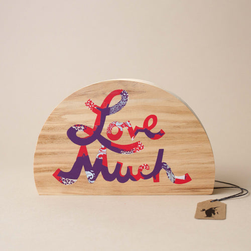 wooden-semi-circle-block-with-love-much-written-in-red-and-purple-script