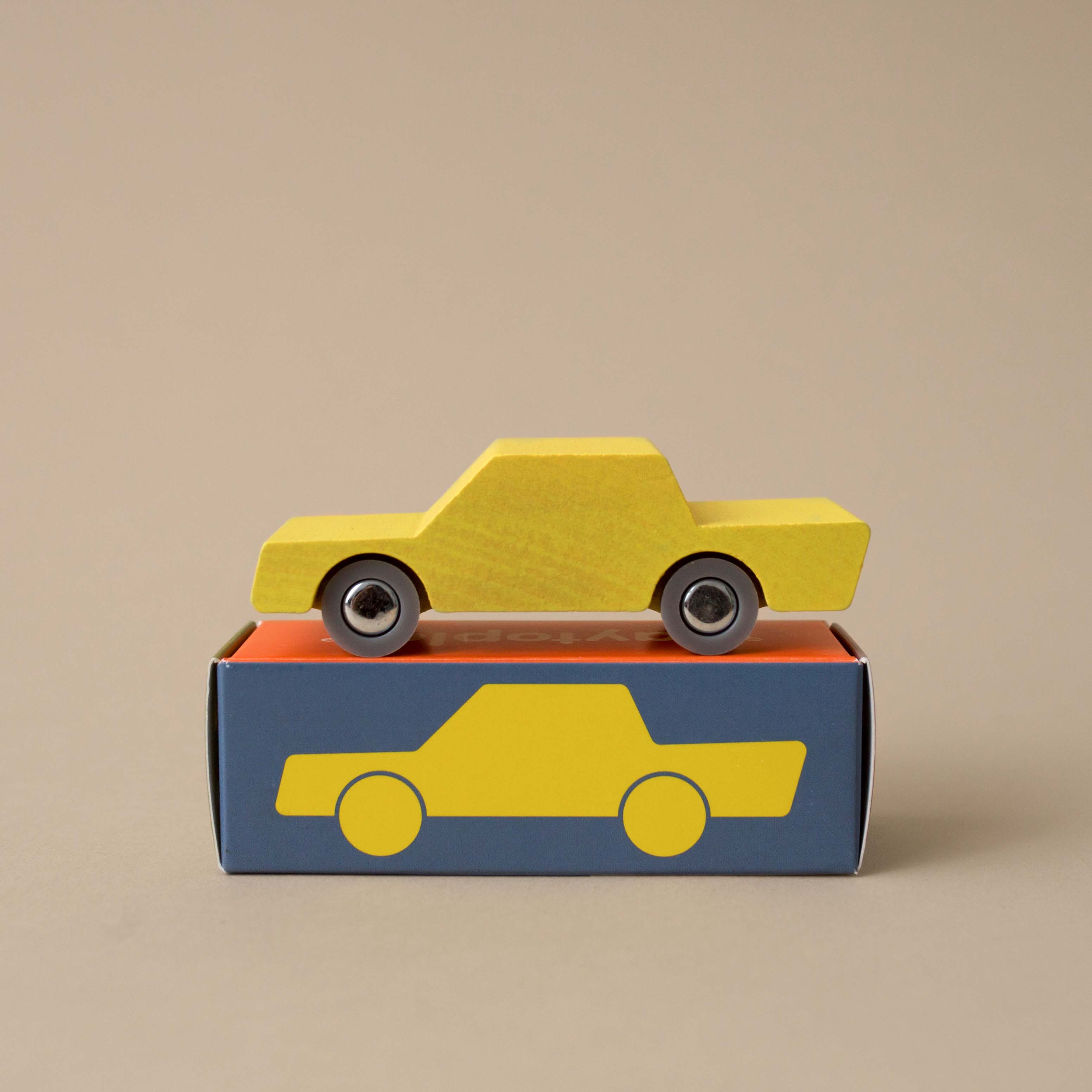 yellow-wooden-back-forth-car-on-top-of-box