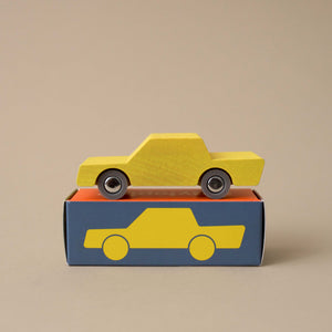 yellow-wooden-back-forth-car-on-top-of-box