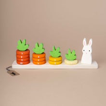 Load image into Gallery viewer, wooden-base-with-numbered-rings-from-one-to-ten-in-different-oragne-tones-stacked-like-small-carrots-and-a-small-white-bunny