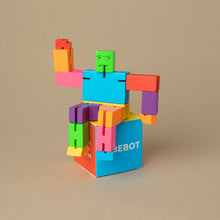 Load image into Gallery viewer, multi-color-wooden-cubebot-sitting-on-top-of-box