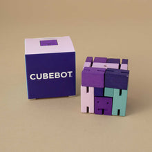 Load image into Gallery viewer, purple-toned-cubebot-in-cube-form-next-to-box