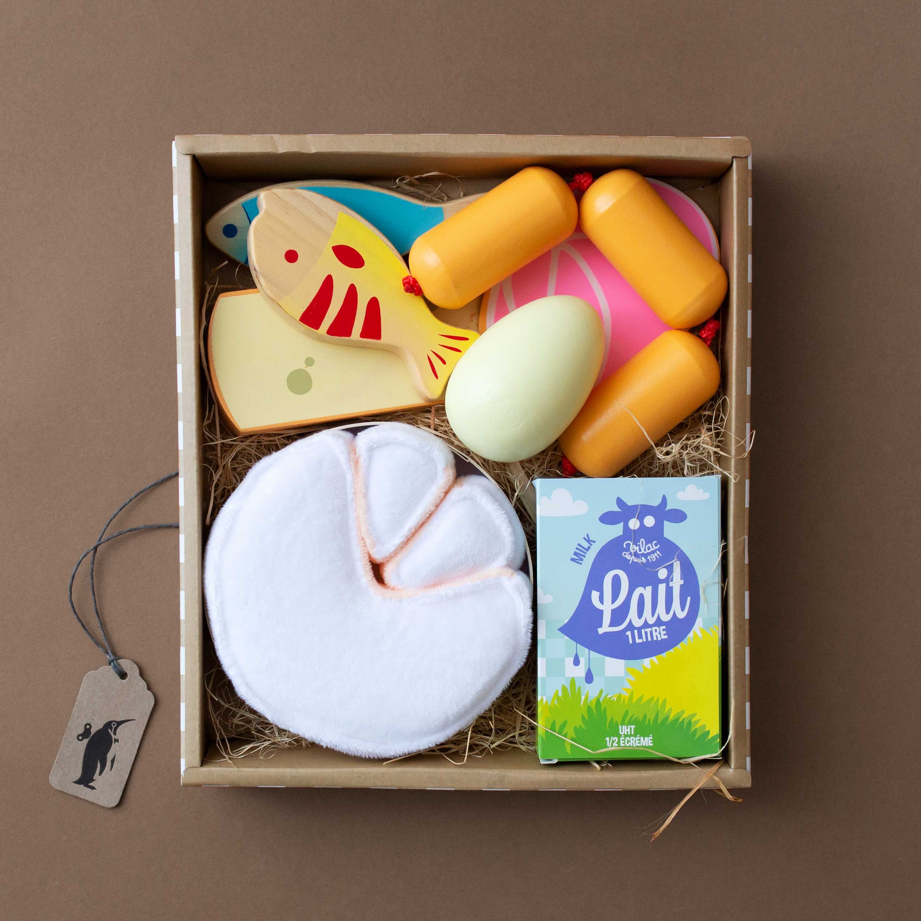 fake-food-items-in-crate-with-paper-grass