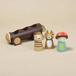 bear-deer-and-mushroom-dolls-next-to-log-shaped-taxi
