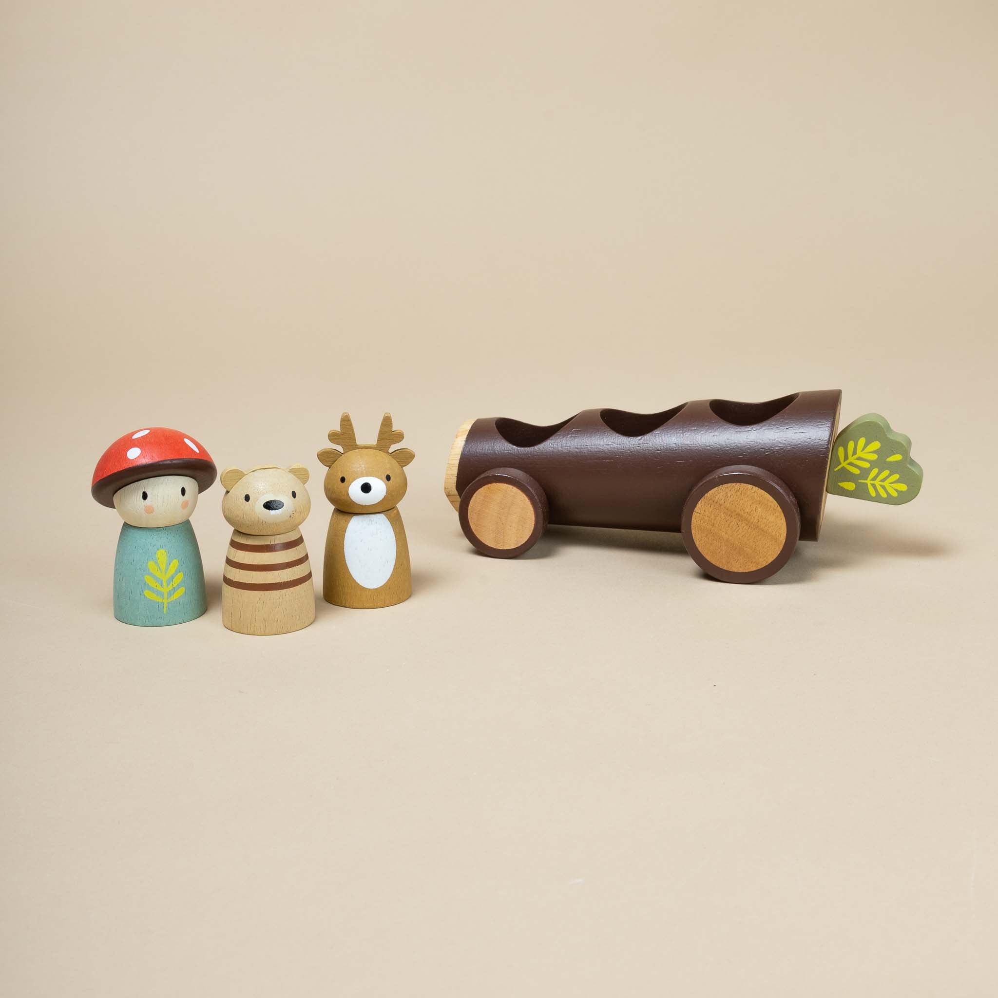 bear-deer-and-mushroom-dolls-next-to-log-shaped-taxi