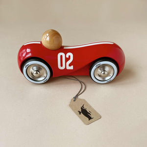 red-wooden-vintage-stremlined-car-with-white-paint-racing-stripes-and-integrated-driver-in-natural-finish