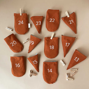 woodland-advent-calendar-rust-brown-cotton-pockets-numbered-with-clothespins-and-string-to-hang-up