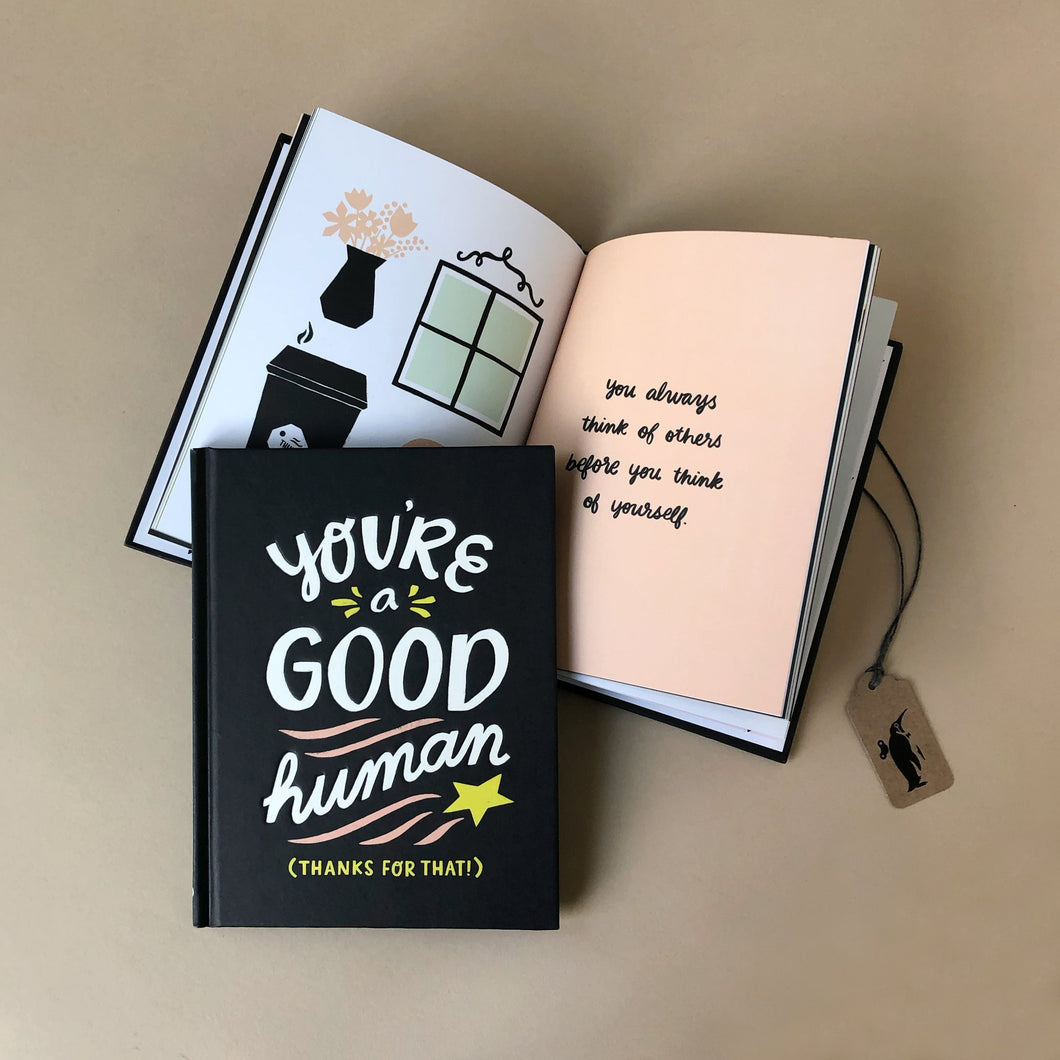 youre-a-good-human-book-black-cover-and-inside-pages-showing-illustrations-of-home-goods-and-text-saying-how-you-always-think-of-others
