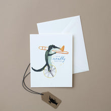 Load image into Gallery viewer, white-card-alligator-on-unicycle-playing-trombone